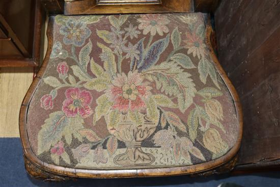 A pair of George I style walnut and parcel-gilt dining chairs